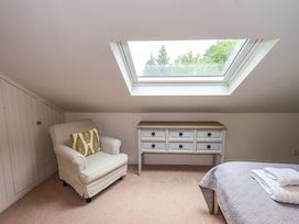 A bedroom with a skylight and furniture at Underheron in Grasmere