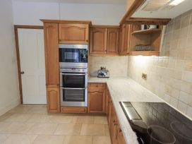 A kitchen with appliances and cabinets at Miyanli in Bowness