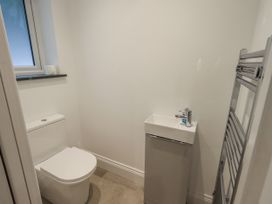 A bathroom with a toilet and sink at Miyanli in Bowness
