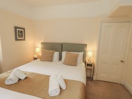 A bedroom with a double bed and lamps at Miyanli in Bowness