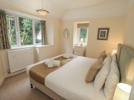 A bedroom with a bed and window at Miyanli in Bowness