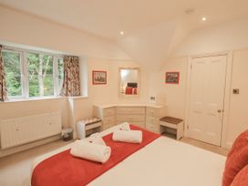 A bedroom with a bed and dresser at Miyanli in Bowness