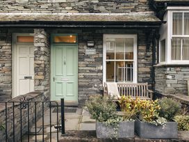 An entryway with two front doors and a bench at Herdwick Cottage Ambleside