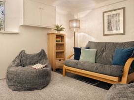 A snug with a sofa and bean bag chair at Herdwick Cottage Ambleside