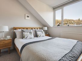 A bedroom with a bed and window at Herdwick Cottage Ambleside