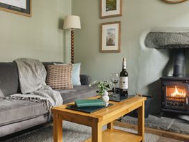 A living room with a sofa and a coffee table at Herdwick Cottage Ambleside
