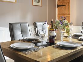 A dining room with a table set for a meal at Herdwick Cottage Ambleside