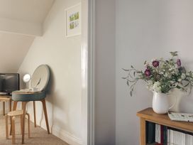 A bedroom with a table and television at Herdwick Cottage Ambleside