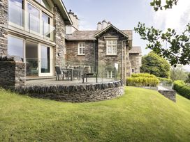 A house with a deck and dining area at Take Five in Ambleside