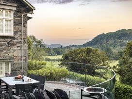 An outdoor dining area with a view of hills at Take Five in Ambleside
