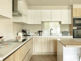 A kitchen with appliances and cabinets at Take Five in Ambleside