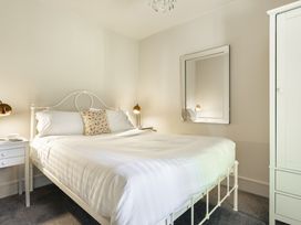 A bedroom with a bed and nightstand at Take Five in Ambleside