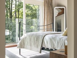 A bedroom with a bed and a mirror at Take Five in Ambleside