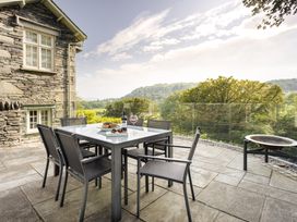 An outdoor seating area with a table and chairs at Take Five in Ambleside