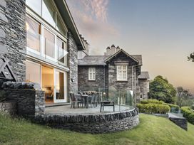 A patio area with a table and chairs at Take Five in Ambleside