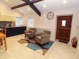 A kitchen with chairs and a table at Cragfell Cottage in Cartmel Fell