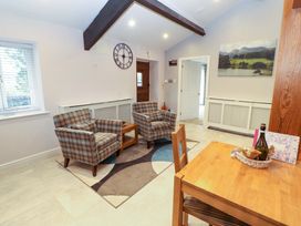 A living room with chairs and a table at Cragfell Cottage in Cartmel Fell