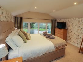 A bedroom with a bed and a television at Cragfell Cottage in Cartmel Fell