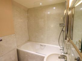A bathroom with a bathtub and shower at Abbots Reading Mews 2 Grizedale