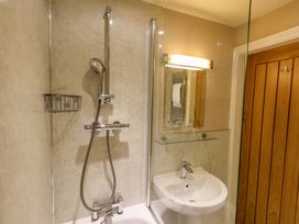 A bathroom with a shower and sink at Abbots Reading Mews 2 Grizedale