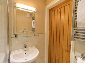 A bathroom with a sink and mirror at Abbots Reading Mews 2 in Grizedale