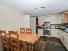 A kitchen with a dining table and chairs at Woodside West in Bowness