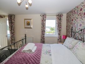 A bedroom with a bed and a window at Woodside West in Bowness