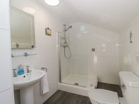 A bathroom with a shower, sink, and toilet at Woodside West Bowness