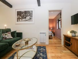 A living room with a sofa and coffee table at Corner Cottage in Troutbeck