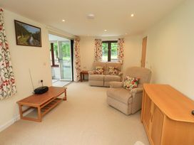 A living room with a sofa and coffee table at Rowanberry Cottage in Grasmere