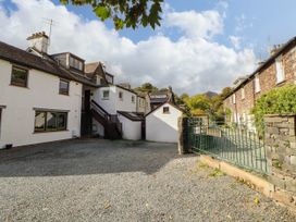 An outdoor area with buildings and gravel at High Raise in Grasmere