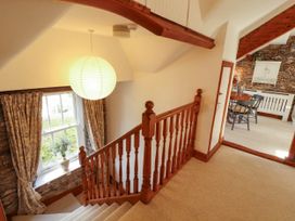 A staircase leading to a dining area at High Raise in Grasmere