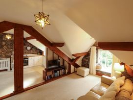 A living room with a sofa and television at High Raise in Grasmere