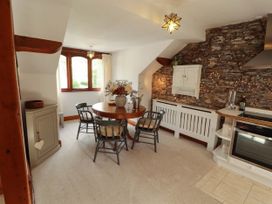 A dining area with a round table and chairs at High Raise in Grasmere