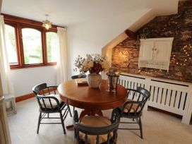 A dining room with a round table and chairs at High Raise in Grasmere