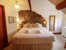A bedroom with a bed and mirror at High Raise in Grasmere