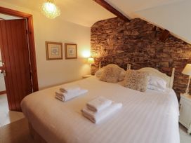 A bedroom with a bed and bedside tables at High Raise in Grasmere