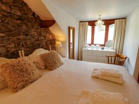 A bedroom with a bed and dresser at High Raise in Grasmere