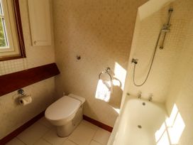 A bathroom with a toilet and bathtub at High Raise in Grasmere