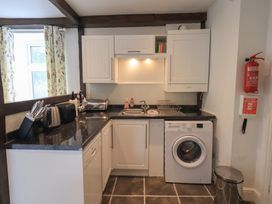 A kitchen with a washing machine and sink at A River Runs By Staveley