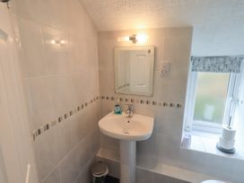 A bathroom with a sink and mirror at A River Runs By Staveley