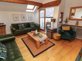 A living room with sofas and a coffee table at Workshop Cottage in Bowness