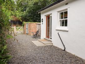 An outdoor area with a gravel path and chairs at Abbots Reading Suite in Lakeside