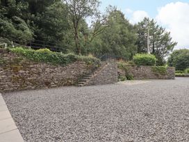 An outdoor area with a stone wall and staircase at Abbots Reading Suite, Lakeside