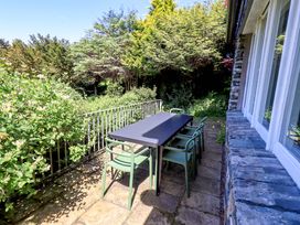 An outdoor area with a table and chairs at Tower Cottage in Windermere