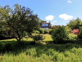 A house surrounded by trees and bushes at Tower Cottage Windermere