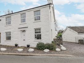 A house with windows and a front door at Smithy Cottage at Bowland Bridge Bowness