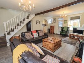 A living room with a sofa and coffee table at Smithy Cottage at Bowland Bridge Bowness