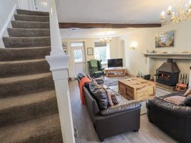 A living room with a sofa and armchairs at Smithy Cottage at Bowland Bridge in Bowness