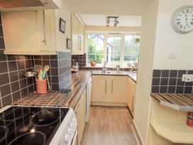 A kitchen with cabinets and a sink at Smithy Cottage at Bowland Bridge Bowness